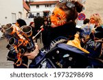 Small photo of Augsburg, Germany - March 3, 2014: Female shawm carnival band member playing the medieval instrument dressed up in a fantasy costume and facial makeup