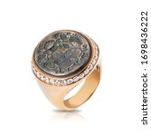 Small photo of Pink signet ring with diamonds inlaid with an old coin isolated on white background