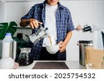 Man using Italian classic Moka coffee pot pouring, coffee maker with equipment tool brewing table. 