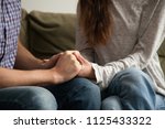 Close up view of couple holding hands, loving wife supporting or comforting husband ready to help expressing sympathy, encouraging and understanding in marriage relationships, reconciliation concept