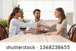 Small photo of Happy female business partners shake hands sign two contracts with lawyer mediation at meeting, smiling businesswomen handshake make legal partnership deal after successful negotiations with mediator