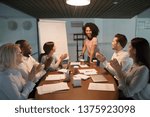 Small photo of Diverse office workers gather together in modern board room sitting at desk welcoming or express gratitude biracial business coach trainer professional people starts or finish evening seminar concept