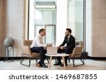 Businessmen discussing deal, sharing startup ideas, business partners negotiations or job interview in modern office with panoramic windows, colleagues talking, working on project together