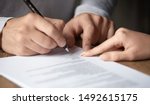 Small photo of Male customer write signature on contract meeting lawyer solicitor, businessman client buyer ready to sign employment insurance sale purchase employment agreement concept make deal, close up view