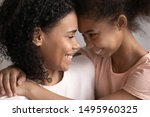 Small photo of Happy mixed-race pre-teen daughter embraces loving mother close up faces family portrait, children is gift most important thing in life, warm relationships, strong connection, deep devotion concept