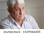 Small photo of Face of senior caucasian hoary man looking away deep in sad thoughts feels lonely close up portrait, recollect memories and life moments, depressed grandfather alone indoors, yearning for wife concept