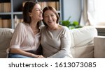 Small photo of Happy senior mother and grownup daughter sit relax on couch in living room talk laugh and joke, smiling overjoyed middle-aged mom and adult girl child rest at home have fun enjoying weekend together