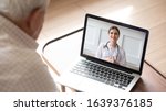 Small photo of Close up of modern elderly man sit at home having online consultation with doctor on computer, sick senior male talk on video call consulting with female nurse using laptop, healthcare concept