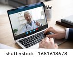 Small photo of Close up of male patient talk consult with doctor using video call on laptop, man speak discuss health problem with physician on webcam virtual conference from home, online consultation concept