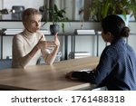 Small photo of Diverse business women sit in front of each other conduct business conversation. Job interview applicant and headhunter talk. Company representative make offer to client convince buy services concept