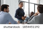 Small photo of Inspired speaker. Confident indian businesswoman convincing thoughtful multiethnic business partners on negotiations, young mixed race female responsible executive making report on corporate briefing