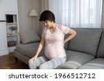 Small photo of Unhealthy young pregnant woman suffer from lower back pain on last month of pregnancy. Unwell tired female have spinal painful feeling or ache from baby bump weight. Maternity, health problem concept.