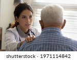 Small photo of We shall fight your disease together. Professional doctor oncologist talk to upset aged male convince to mobilize strength for struggling with cancer. Trusted family therapist support old man patient