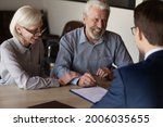 Small photo of Happy mature family couple of clients consulting legal expert, lawyer, solicitor about legal document signing, asking advice, question, talking, celebrating deal, house or medical insurance buying