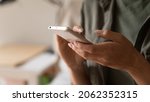 Small photo of Hands of woman holding smartphone, using online app and virtual services cellphone, making video phone call, texting and chatting on messengers, buying online, reading books, articles. Close up