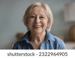 Small photo of Head shot portrait happy beautiful retired woman. Mature female advertises professional services of dental clinic smile look at camera. Carefree life on retirement, medical insurance cover for seniors