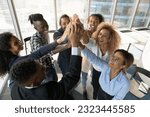 Above top view happy friendly young african american diverse colleagues joining hands in air, celebrating shared corporate success, effective teamwork, raising working spirit, teambuilding concept.