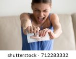 Small photo of Angry hysterical woman tearing photo of happy couple, erasing memories of ex-boyfriend after breaking up divorce, frustrated lovelorn teenager feeling heartbroken ripping picture of past relationship