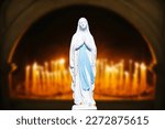 Small photo of Mother Mary pray. Blessed virgin statue. Praying Virgin Mary statue. Religious background. Empty copy space faith background. Saint sculpture isolated on candles background.