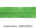 Plastic zipper isolated on white. Fabric fastener. Tailoring object. Object cutout on white. Fastener fashion background. Garment sewing zipper. Green color.