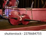 Small photo of An image of a large double bass lying on the theater stage during intermission