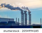 Small photo of The pipes of the a chemical plant, from which thick white smoke rises into the blue clear sky. Air pollution! Exhaust gases, ozone depletion, greenhouse effect. Industrial landscape of Cherepovets.