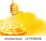 Small photo of Honey dipper with bee honeycomb isolated on white background. Honey tidbit in glass jar and honeycombs wax.