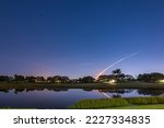 Small photo of View of the launch trajectory of the Artemis 1 rocket with reflection in the lake at Boynton Beach, Florida, USA