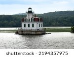 Small photo of Port Ewen, NY – USA – Aug 2, 2022 Horizontal view of the historic wooden Esopus Meadows Lighthouse, nicknamed "Maid of the Meadows".