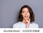 Beautiful attractive pretty lovely cute sweet gorgeous nice lady in style stylish casual outfit with her brunette hair she look aside wide open mouth isolated on gray wall with copy space for text