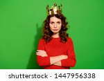 Portrait of her she nice-looking lovely winsome pretty attractive serious bossy selfish wavy-haired girl in red sweater crown feminism isolated on bright vivid shine green background