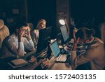 Small photo of Four nice attractive hardworking people leaders top executive skilled managers entrepreneurs launching startup reading IT tech documents online coworking at late night work place station
