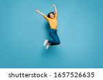 Full length body size view of nice attractive lovely glad cheerful wavy-haired girl jumping having fun rising hands up isolated on bright vivid shine vibrant green blue turquoise color background
