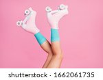 Cropped close-up profile side view of nice attractive lovely long legs wearing blue comfortable socks skates having fun time isolated over pink pastel color background