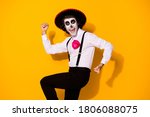Small photo of Photo of spooky monster guy raise hands fists open mouth excited undead toreador win fight mad bull wear white shirt death costume sugar skull suspenders isolated yellow color background