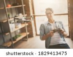 Small photo of Portrait of his he blurred nice attractive cheerful guy geek skilled expert controlling drone trial period guarantee service at modern loft brick open space industrial home office work place station