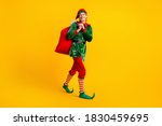Full length body size view of his he nice attractive cheerful funny guy elf going carrying bringing sack gifts delivery Eve Noel isolated over bright vivid shine vibrant yellow color background