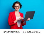 Portrait of intelligent cheerful lady skilled executive assistant holding in hand laptop working remotely isolated bright blue color background