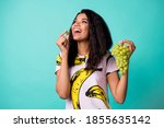 Photo of dark skin lady eat grapevine look copyspace wear pink t-shirt isolated on turquoise color background