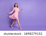 Full length profile portrait of walking girl beaming smile look camera wear vintage isolated on violet color background