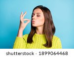 Photo of young attractive woman show gesture perfect tasty sign enjoy meal isolated over blue color background