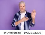 Small photo of Photo of aged man hand on chest make oath promise honest swear isolated over purple color background