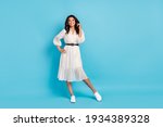 Full length body size view of attractive cheerful girl wearing cozy midi dress posing isolated over bright blue color background