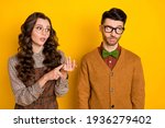 Small photo of Portrait of nice couple girl saying pretense to guy bad mood psychology isolated over bright yellow color background