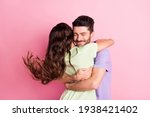 Small photo of Portrait of attractive dreamy gentle amorous cheerful couple embracing air blowing isolated over pink pastel color background