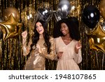 Photo of two stunning girls dance prom balloons funky wear dress isolated on shine tinsel background