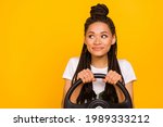 Small photo of Photo of dreamy happy afro american young woman look empty space drive car isolated on yellow color background