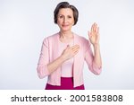 Small photo of Photo of aged woman happy positive smile hold hand swear promise make oath promise tell truth isolated over grey color background