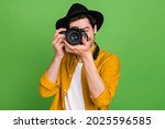 Photo of young handsome professional photographer take picture you camera isolated on green color background