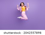Full body profile photo of hooray millennial brunette lady jump wear jacket jeans sneakers isolated on violet background
